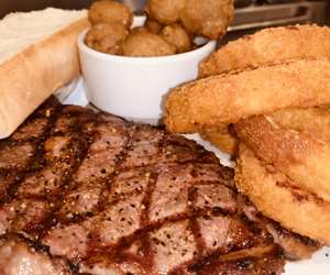 12oz Ribeye with fried mushrooms and onion rings...